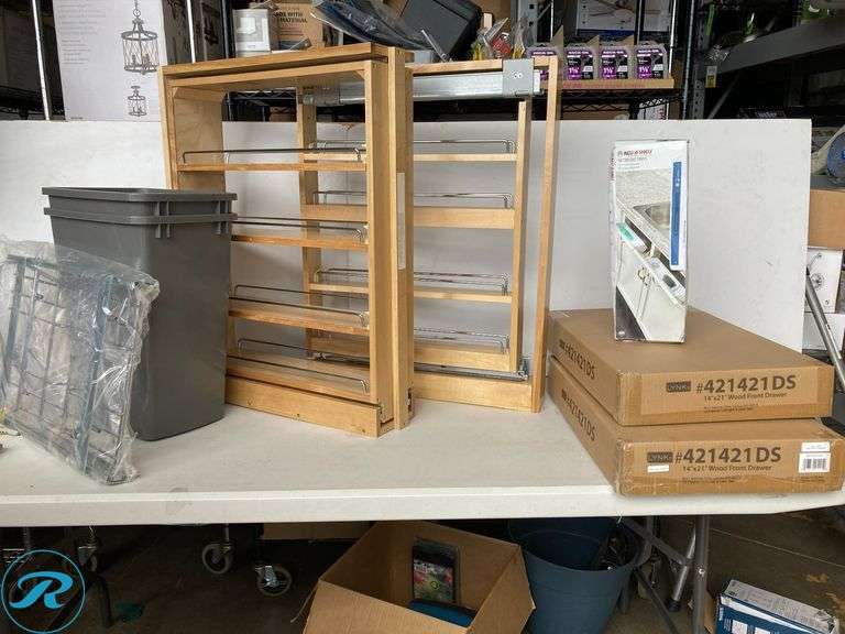 (6) New- Assorted Cabinet Interior Organizers (1) Pull out trash can (2) Pull out spice rack 6" x 30" x 23" and 3" x 30" x 23.5" (2) Pull out cabinet organizer 14" x 4.75" x 21 (1) Cabinet Mount plastic tipout tray