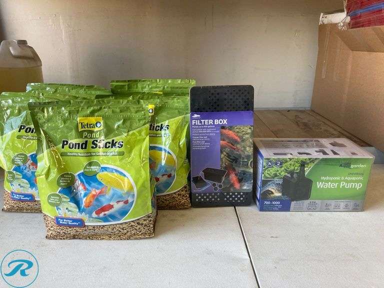 (7) New- (5) Tetra 1lb goldfish and koi 11.25" x 9.5" x 4.75 in green fish food (1) smart pond 12.3" x 63" x 63" black plastic pond pump filter box (1) Pennington 1000 gph submersible corded electric pond pump - Roller Auctions
