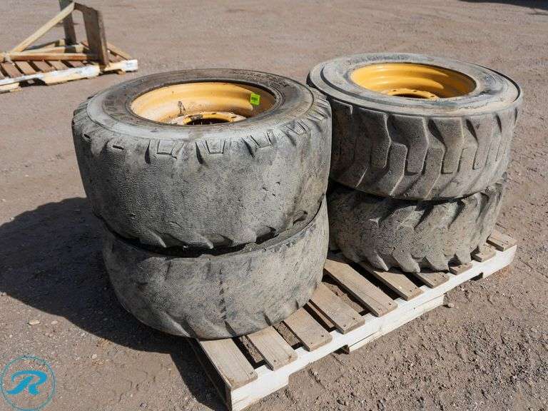 (4) Assorted 12-16.5 Skid Steer Tires With Caterpillar Wheels