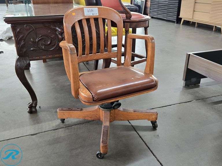 Oak Swivel Office Chair With Brown Vinyl Cushion And Casters