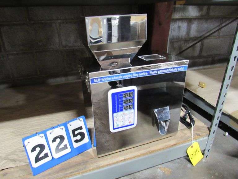 MULTI FUNCTION AUTOMATIC WEIGHING FILLING MACHINE, STAINLESS STEEL, ACCEPTS SOLIDS OR POWDERS AND PORTIONS OUT IN GRAMS OR OUNCES