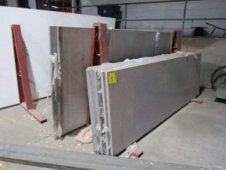 (13) ASSORTED STONE SLABS INCLUDING (10) APPROX. 110" X 35" X 1", (2) APPROX. 112" X 52" X 1" AND (1) APPROX. 108" X 64" X 1" SOLD WITH (2) PAIRS OF METAL A-FRAMES AS SHOWN
