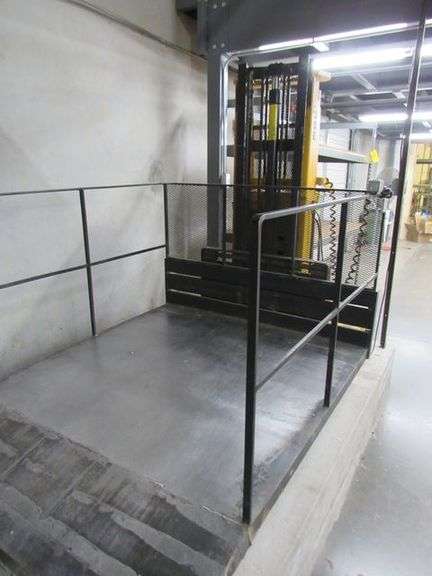 BIG JOE WALK BEHIND ELECTRIC LIFT TRUCK MDL. 2024-T9, S/N 353867, 2,000 LB CAPACITY, 108" LIFT HEIGHT, HARD WIRED TO OUTLET, W/5' X 76" METAL SAFETY CAGE W/RAMP, (DELAYED PICKUP), (BUYER RESPONSIBLE FOR UNBOLTED AND UNWIRED)