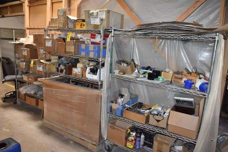 LOT, (2) WIRE RACKS AND (1) WIRE SHELF WITH ASSORTED HARDWARE FOR BUILDING RECLINERS, (1) PALLET, RECLINER PARTS AND (1) PILE OF RECLINER MOTOR ASSEMBLIES AS SHOWN