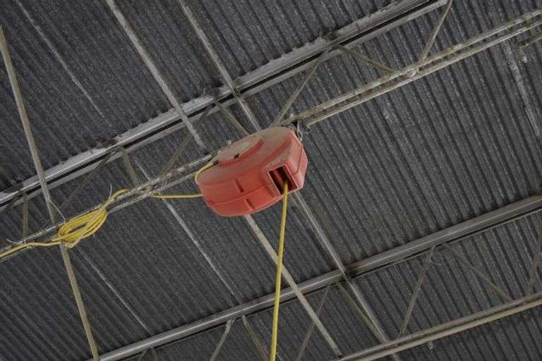 ELECTRIC CORD REEL ATTACHMENT  *BOLTED TO CEILING - BUYER WILL NEED TOOLS AND LADDER TO REMOVE FROM THE CEILING TRUSS*  (sold 2x the money)