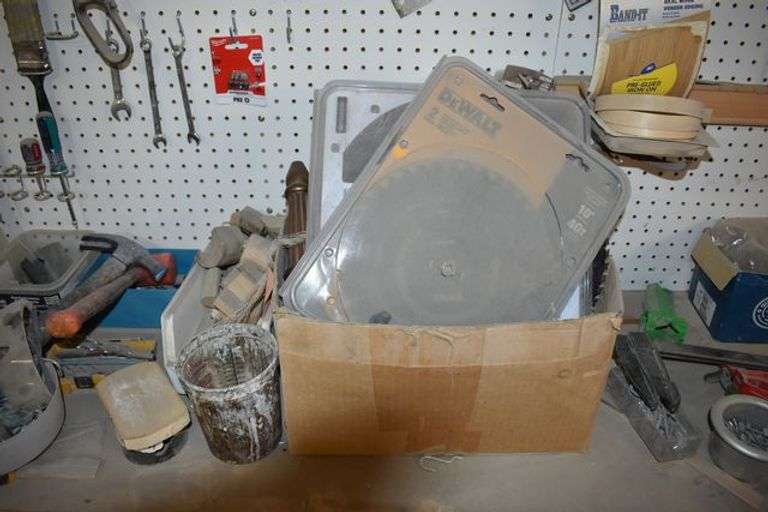 CONTENTS ON WORKBENCH AND PEG BORAD INCLUDING EAR PROTECTION, WRENCHES, SAWS AND CLAMPS
