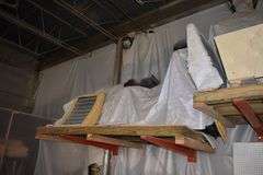 CONTENTS OF (2) SETS OF CANTILEVER RAKS *MOSTLY PLYWOOD WITH APPROX.  (15) GOOD 4' X 8' SHEETS AND APPROX. (45) SHEETS OF USED PLYWOOD, FURNITURE PARTS, A/C BLOWERS AND MORE AS SHOWN