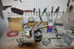 CONTENTS ON WORKBENCH AND PEG BORAD INCLUDING EAR PROTECTION, WRENCHES, SAWS AND CLAMPS