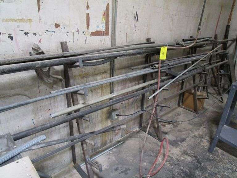 LOT, (5) METAL RACK STANDS BOLTED TO FLOOR, W/ASSORTED METAL TUBING, ETC.