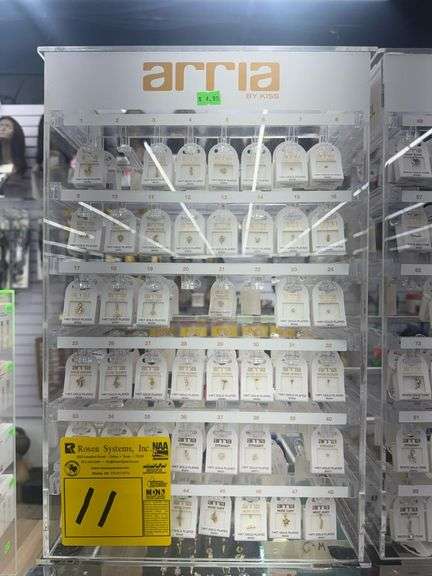(3) Assorted Plexiglass Jewelry Display Racks w/ Jewelry. Includes (2) Arria by KISS 12” X 7” X 19” , and (1) EireM 12” X 4” X 14”. Includes Arra Body Jewelry and Earrings
