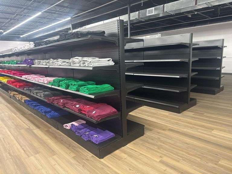(32) Sections of (Empty) Metal Double-Sided Gondola Shelving Units. Each Section has Four Adjustable Height Shelves. Each Measures Approximately 47” X 37” X 65”. Delayed Pick Up Required.
