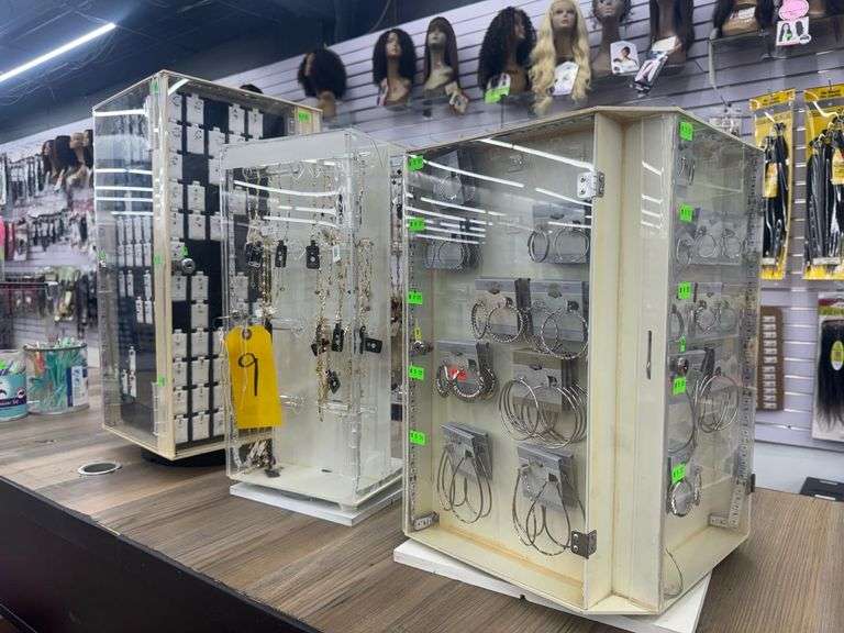 Lot of (3) Assorted Rotating and Locking Table Top Jewelry Display Cases w/ Fashion Jewelry. Includes Body Jewelry, Necklaces, and Earrings. Single Key fits all (3).