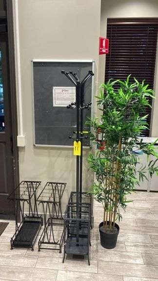 Lot (2) Coat Racks, (2) Metal Racks, (1) Plant, & (1) Info Display Wall board