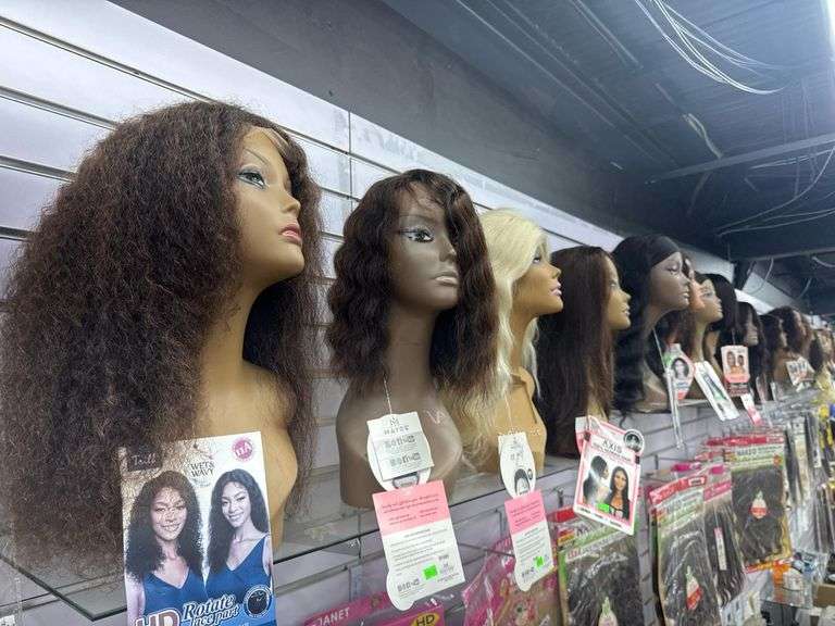 (27) Assorted 100% Human Hair Wigs w/ Mannequin Head Displays. Includes Axis, Mayde, Sensationnel, Trille, and Cloude 9