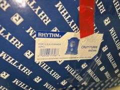 RHYTHM Woodgrain Spiral Pendulum Clock