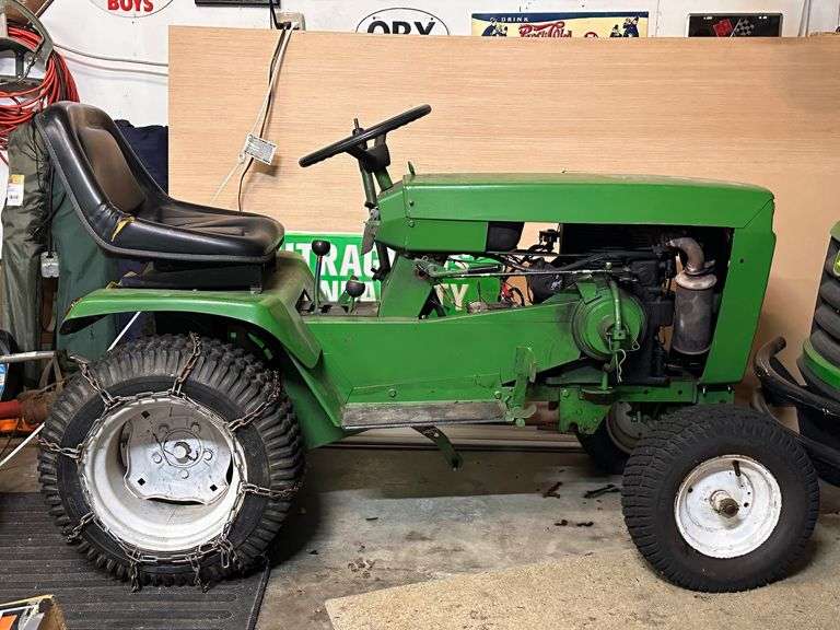 Green Lawn Tractor with Snow Blade and Mowing Deck