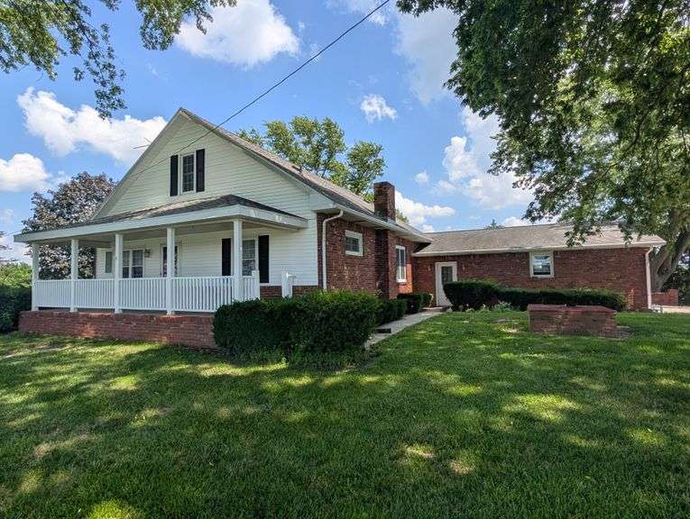Tract 5 – 4.28+/- Surveyed Acres with Brick Farmhouse with Metal Machine Shed, Traditional Barns, Brooder House & Grazing Pasture  Enjoy Evening views sitting atop Hill overlooking Clearview Road from your covered Front Porch!