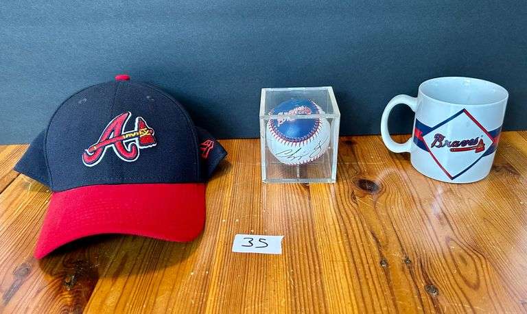 3pc Atlanta Braves Hat, Baseball (Signed by Chipper Jones) and Cup (Located in Kitchen)