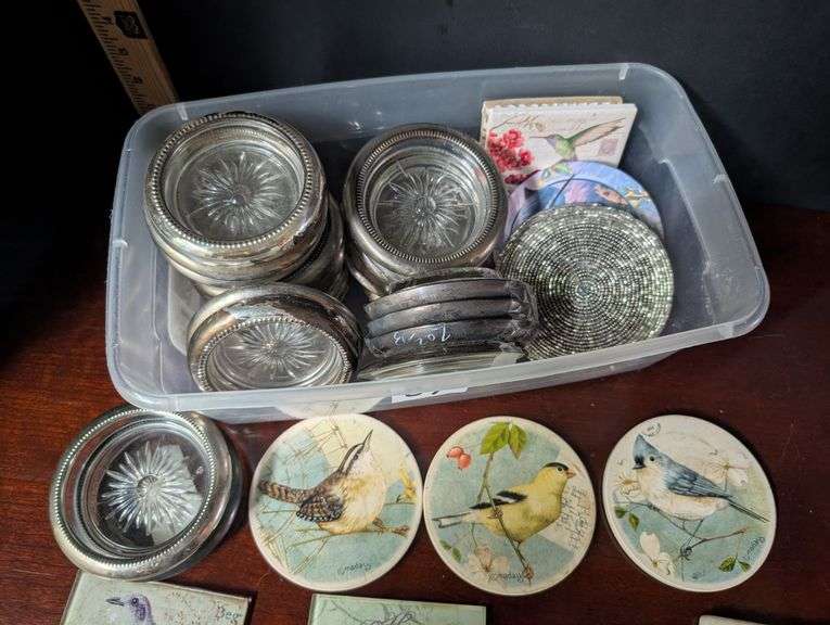 Small tote full of various designs coasters(located in ds back bedroom)