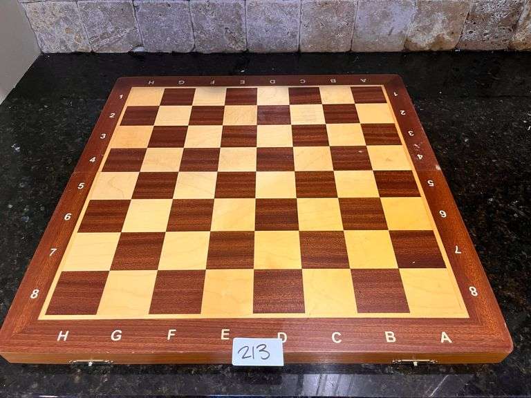 Wooden chess set: board w/ storage and all pieces (located in kitchen)