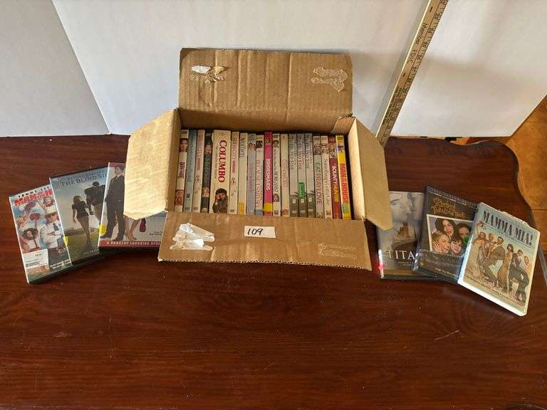 Box of DVDs, Mamma Mia!, Titanic, etc. (Located in ds back room)