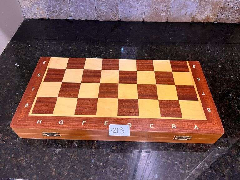Wooden chess set: board w/ storage and all pieces (located in kitchen)