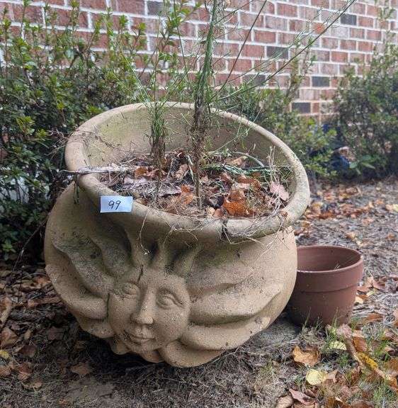 Large sun design cement planter 17" diameter 18" talland small terracotta planter(located on side of