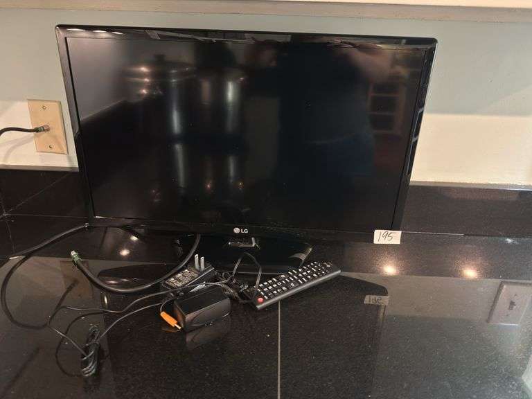 LG TV, 22"long, 15" tall with stand (located in kitchen)