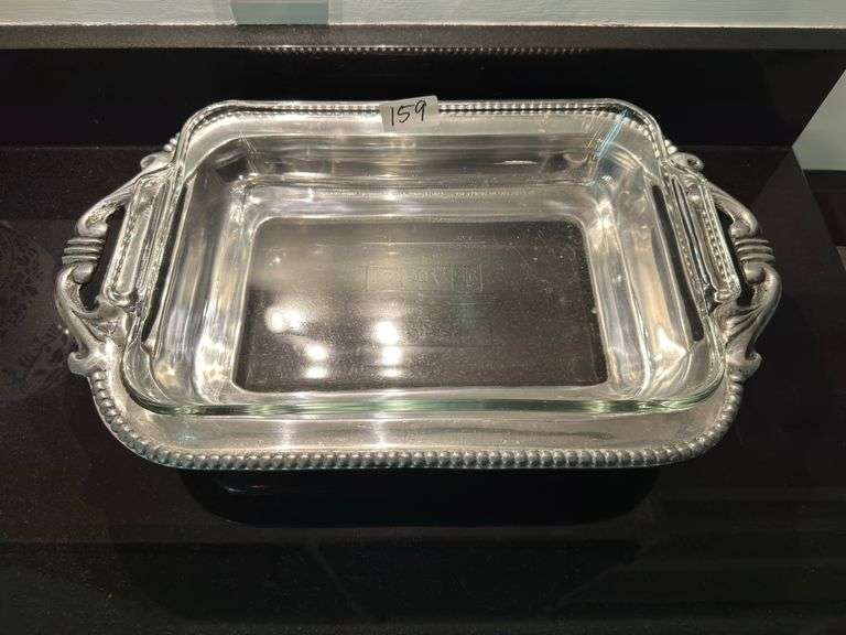 Silver casserole dish holder and casserole dish (located in kitchen)