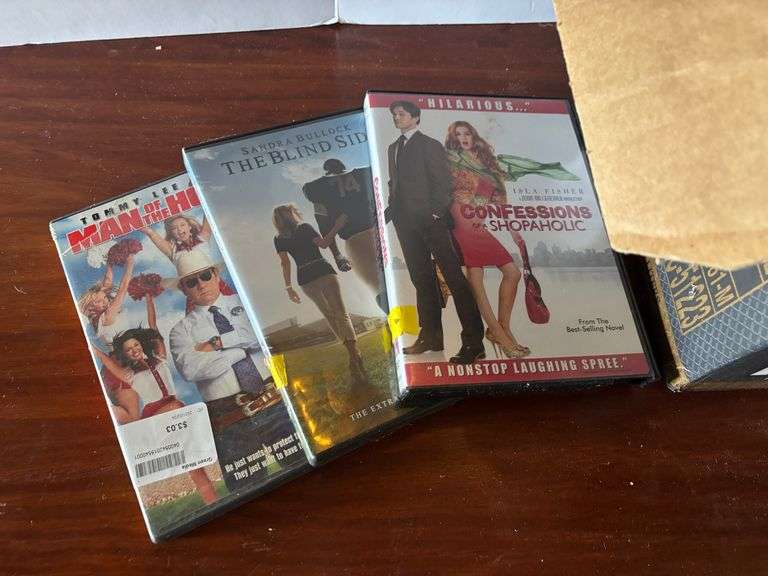 Box of DVDs, Mamma Mia!, Titanic, etc. (Located in ds back room)