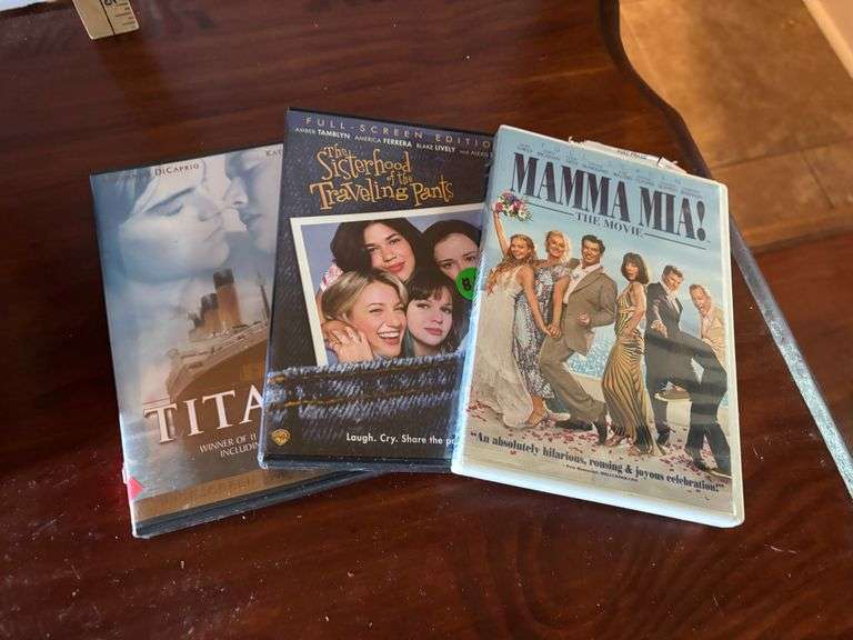 Box of DVDs, Mamma Mia!, Titanic, etc. (Located in ds back room)