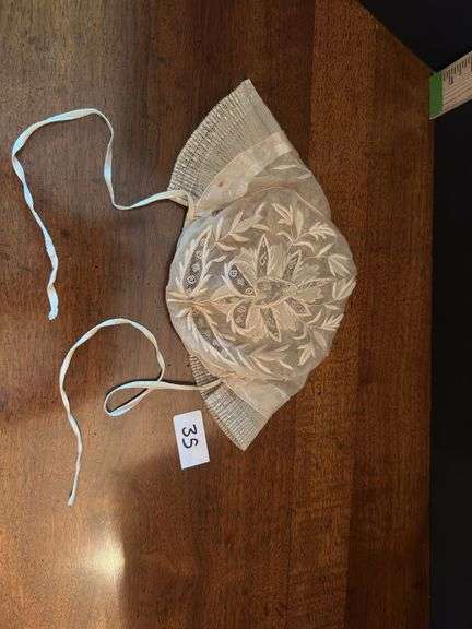 Vintage lace baby bonnet and 6 crochet high ball coasters (located in drawer in china cabinet)
