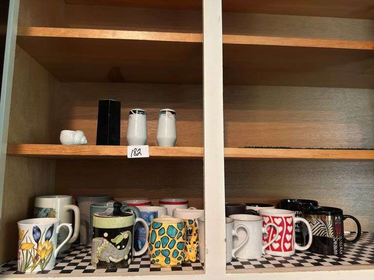 Lot of 16 mugs, salt and pepper shaker)located in kitchen )