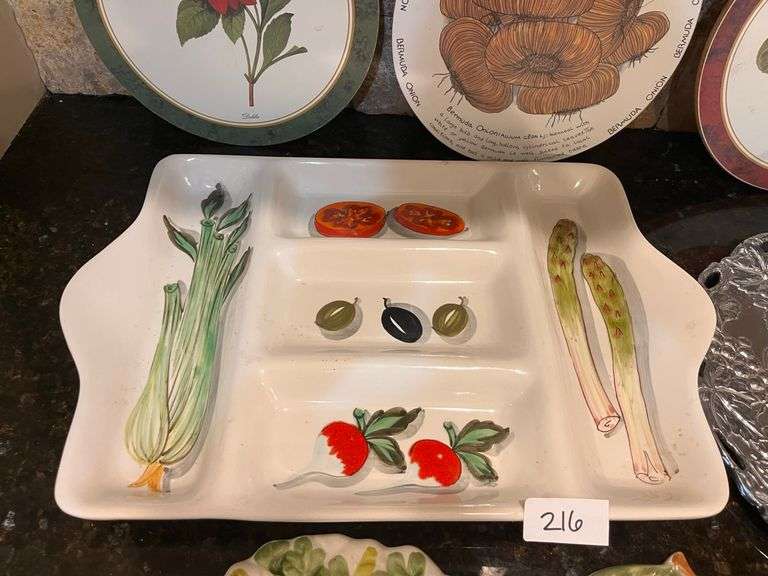 Fruit and vegetable serving trays, wall hangings, and colander (located in kitchen)