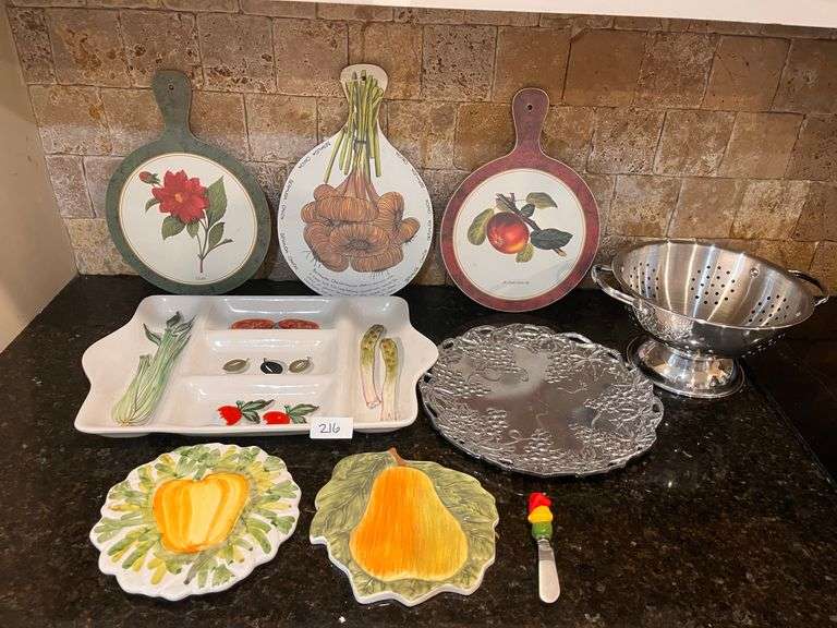 Fruit and vegetable serving trays, wall hangings, and colander (located in kitchen)