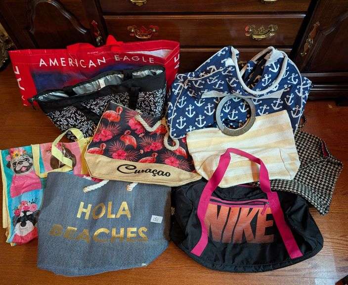 10 pc. Nike duffel bag, igloo bag, and tote bags (located in DS back bedroom)