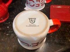 Red mixing bowl, mugs, 3 pc ramekins with lids, and creamer pitcher (located in kitchen)