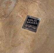 Vintage brass vase handmade in India with wood stand(located in family room)