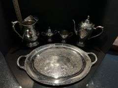 Silver plated coffee/tea service set includes pitcher (located in dining room)