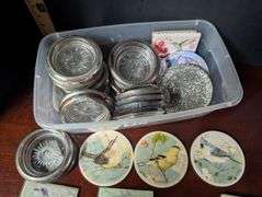 Small tote full of various designs coasters(located in ds back bedroom)