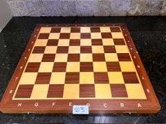 Wooden chess set: board w/ storage and all pieces (located in kitchen)