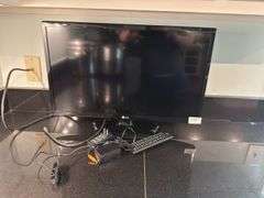 LG TV, 22"long, 15" tall with stand (located in kitchen)