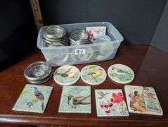 Small tote full of various designs coasters(located in ds back bedroom)