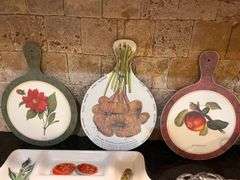 Fruit and vegetable serving trays, wall hangings, and colander (located in kitchen)