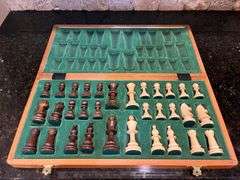 Wooden chess set: board w/ storage and all pieces (located in kitchen)