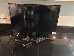 LG TV, 22"long, 15" tall with stand (located in kitchen)