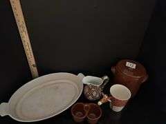 Pottery crock and condiment caddy, giraffe mug, pitcher and casserole dish (located in kitchen)