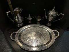 Silver plated coffee/tea service set includes pitcher (located in dining room)