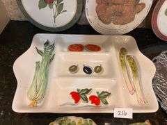 Fruit and vegetable serving trays, wall hangings, and colander (located in kitchen)