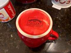 Red mixing bowl, mugs, 3 pc ramekins with lids, and creamer pitcher (located in kitchen)